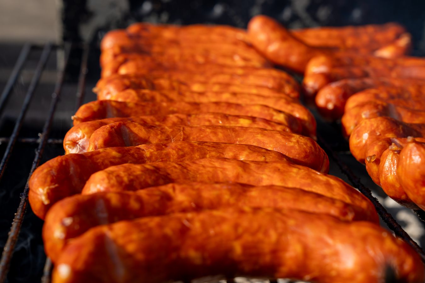 Chorizo sausages lined up over the charcoal