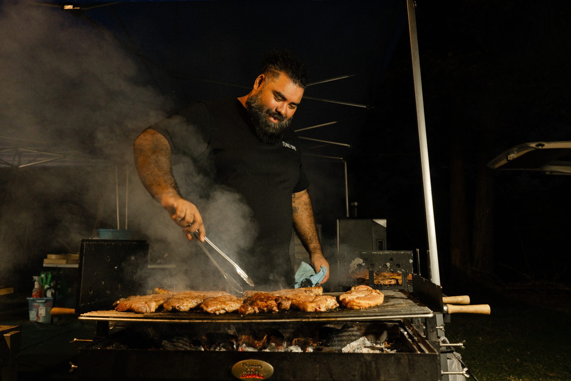 Tunu Bro pitmaster cooking over charcoal at an event in Sydney