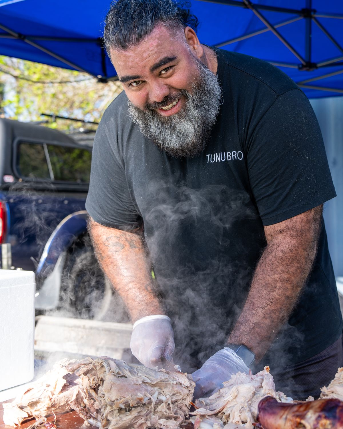 James, known as Misi, pulling slow-roasted pork at a Tunu Bro catering job in Sydney