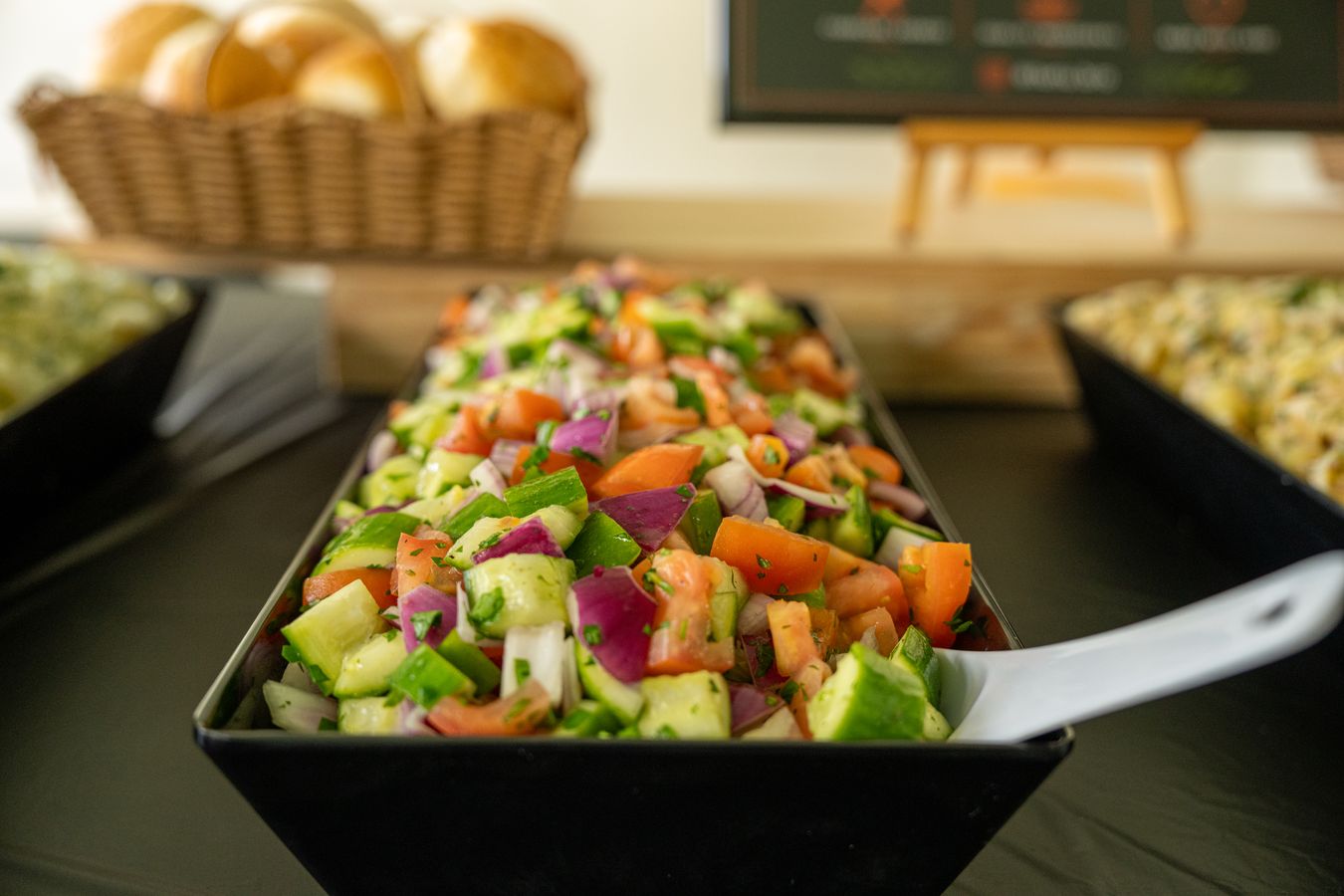Fresh tomato, cucumber and red onion salad in a serving tray
