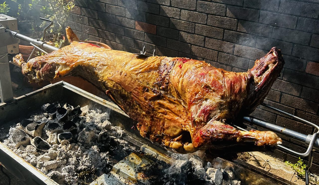 Whole lamb on the charcoal spit